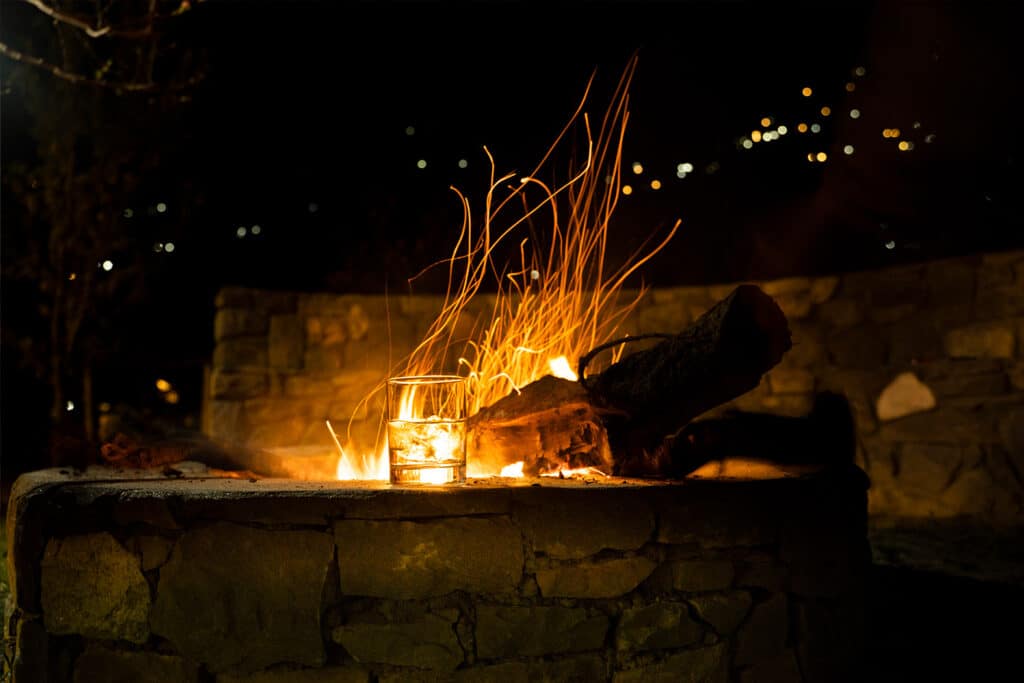 A cosy fire pit crackles warmly